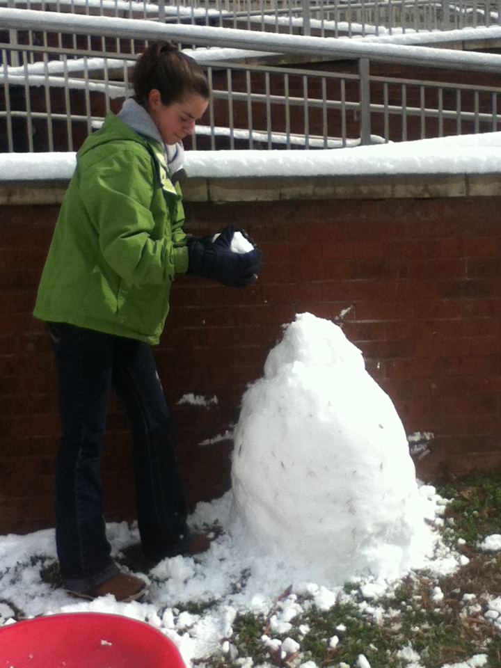 Snow Day 2013 2 Ashely Coke makes her first snowman outside of Central Drive residence hall. Photo by Brandy Carl.
